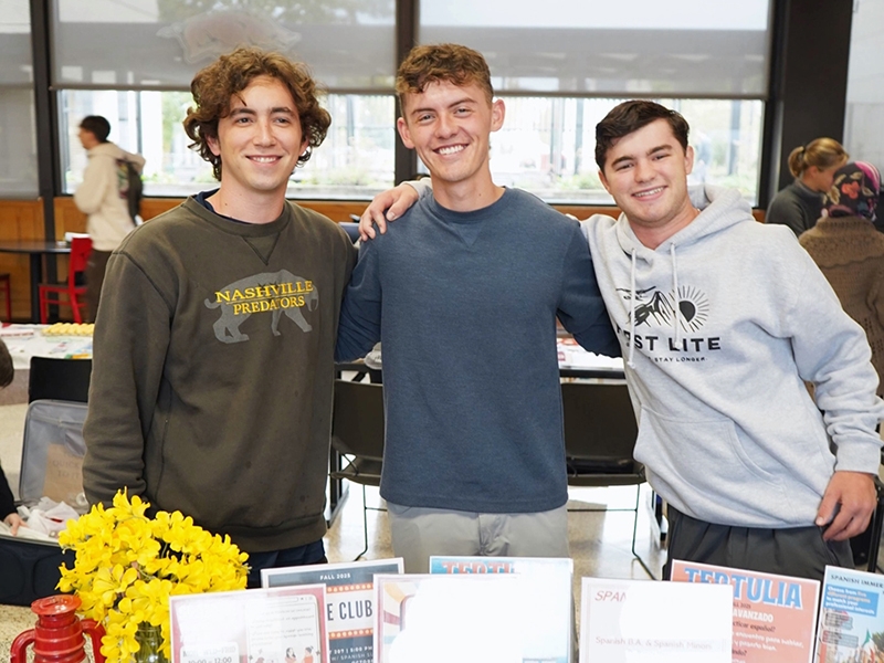 Pictured from left: Christian Smith, Cohen Martinez, and Stanley Fowler volunteering at the Spanish Program's table at the Language and Culture Connections Fair on October 27. Pictured from left: Christian Smith, Cohen Martinez, and Stanley Fowler volunteering at the Spanish Program's table at the Language and Culture Connections Fair on October 27.