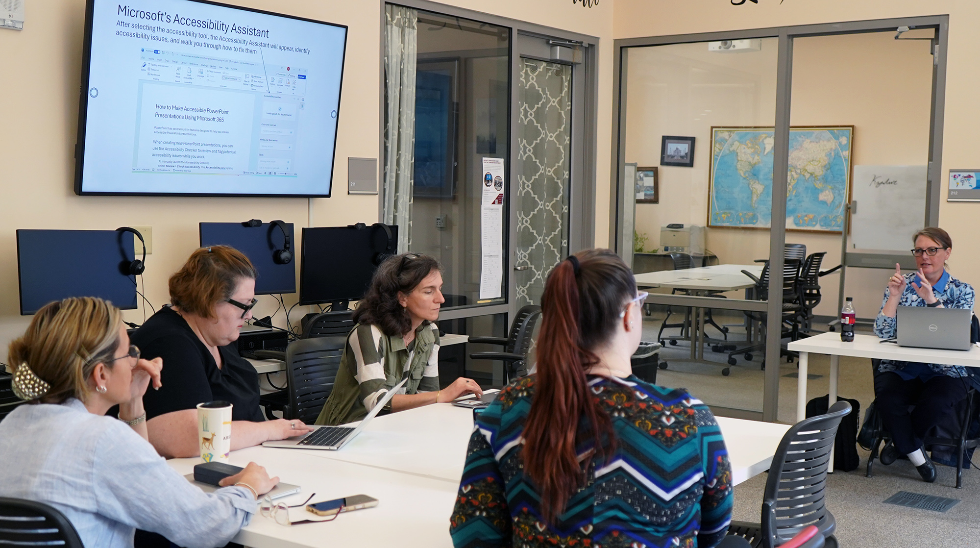 Accessibility Workshop led by Deirdre Slavik (far right) on April 16, 2026. Deirdre Slavik (far right) leading the Accessibility Workshop to WLLC participants on April 16, 2026. There are four participants pictured along with Deirdre Slavik in the World Language and Digital Humanities Studio.